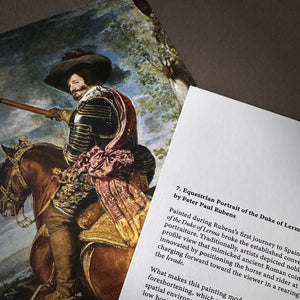 A close-up of an artcard showing a text excerpt about a historical equestrian portrait by Peter Paul Rubens, with part of the adjacent artwork visible depicting Velasquez's version.