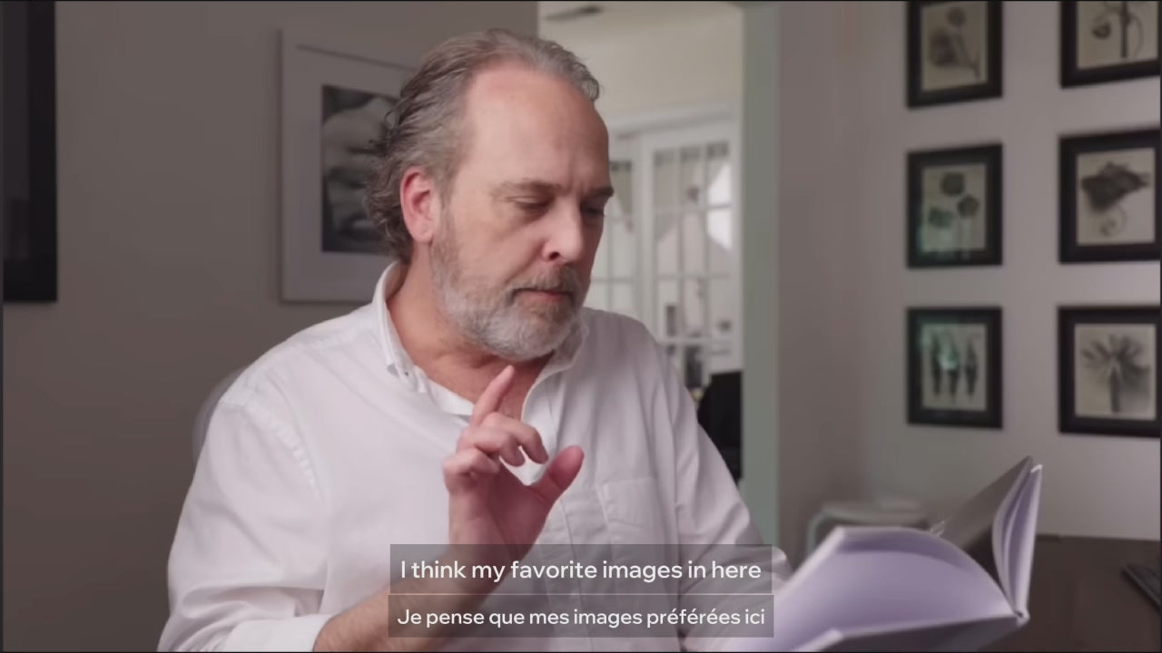 View of Ted Forbes from The Art of Photography holding and reviewing My Boxing Life Japan photobook